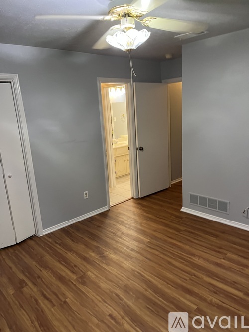 A room with wooden floors and a chandelier.