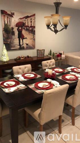 A dining room with a table set for a meal.