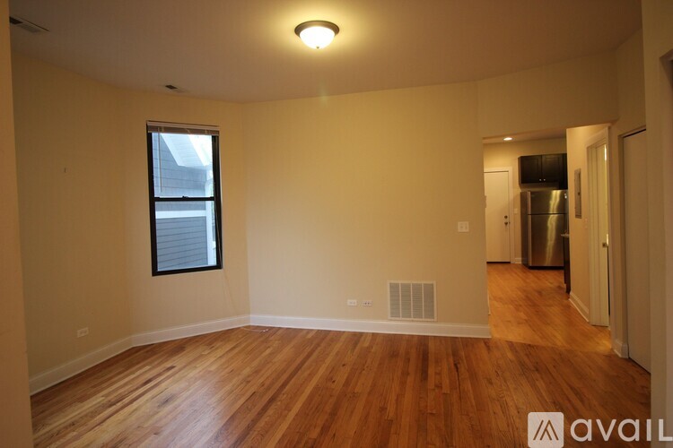A room with wooden floors and a window.