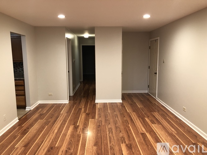 A room with wooden floors and white walls.