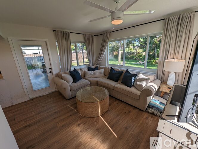 A living room with a large couch and a television.
