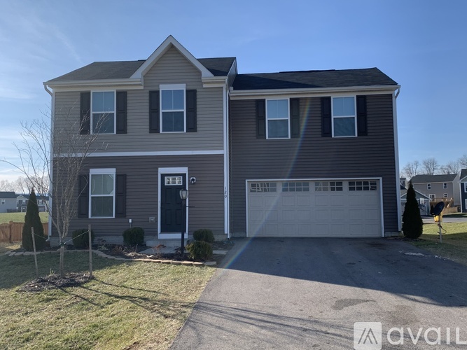 A two-story house with a garage is available for rent.