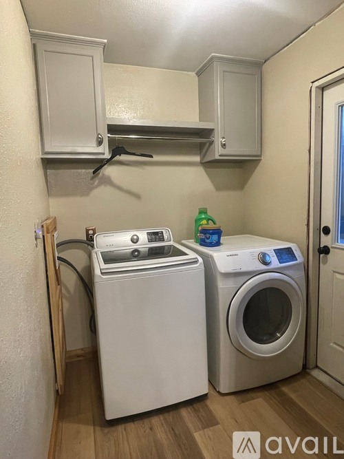 A small laundry room with a washer and dryer.