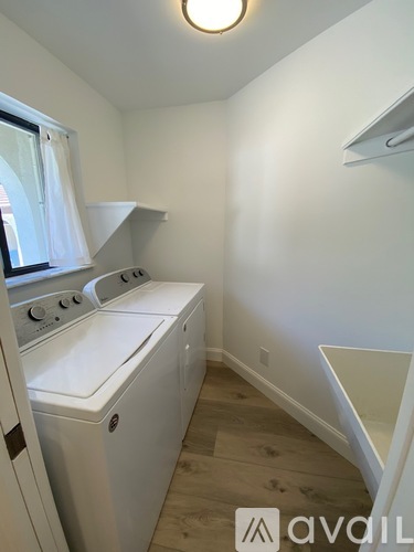 A small laundry room with a washer and dryer.