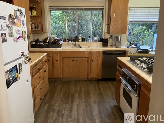 A kitchen with a white fridge and wooden cabinets.