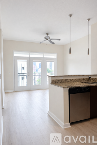 A kitchen with a counter and a fan on the ceiling.