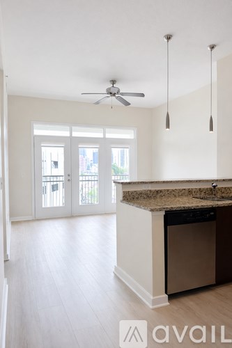 A kitchen with a counter and a fan on the ceiling.