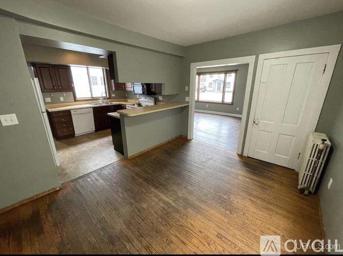 A room with wooden floors and a white door.