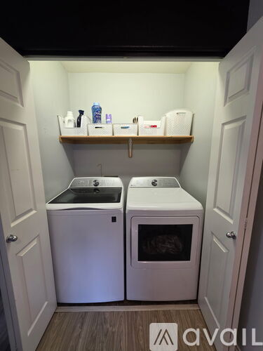 A small laundry room with a washer and dryer.