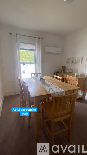 A dining room with a table and chairs.