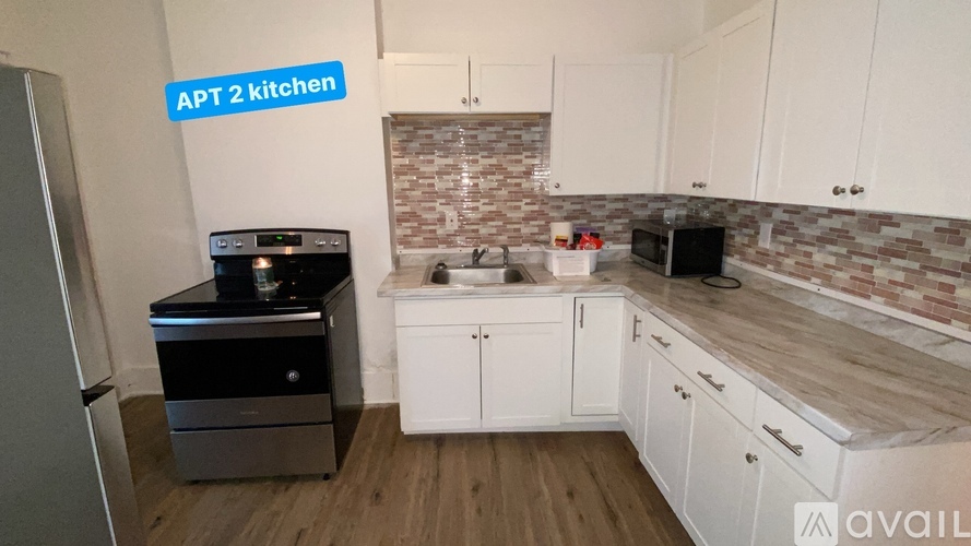 APT 2 kitchen with a fridge, microwave, and oven.