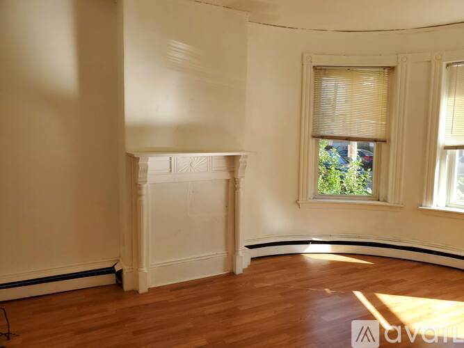 A room with a fireplace and a window.
