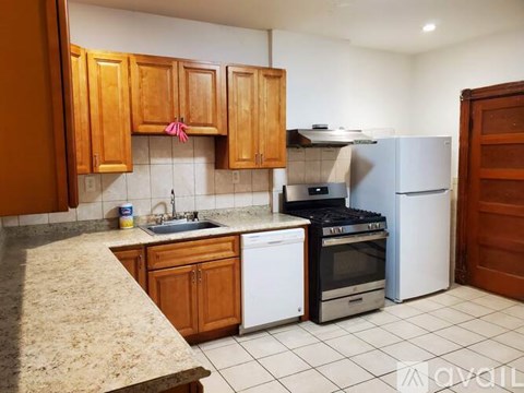 A kitchen with wooden cabinets and a white dishwasher.