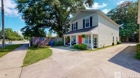A house with a red door is for sale.