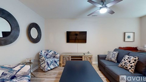 A living room with a dark blue couch and a wooden coffee table.
