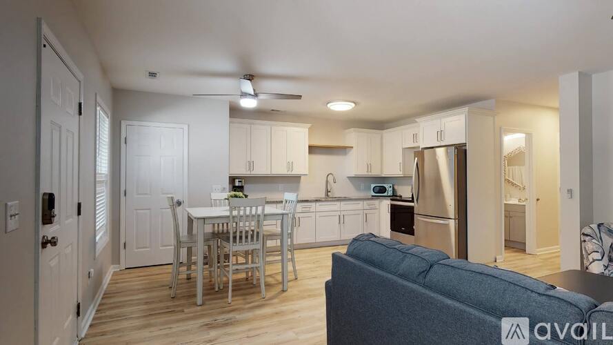 A kitchen with a table and chairs in the middle of the room.