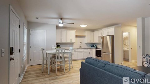 A kitchen with a table and chairs in the middle of the room.