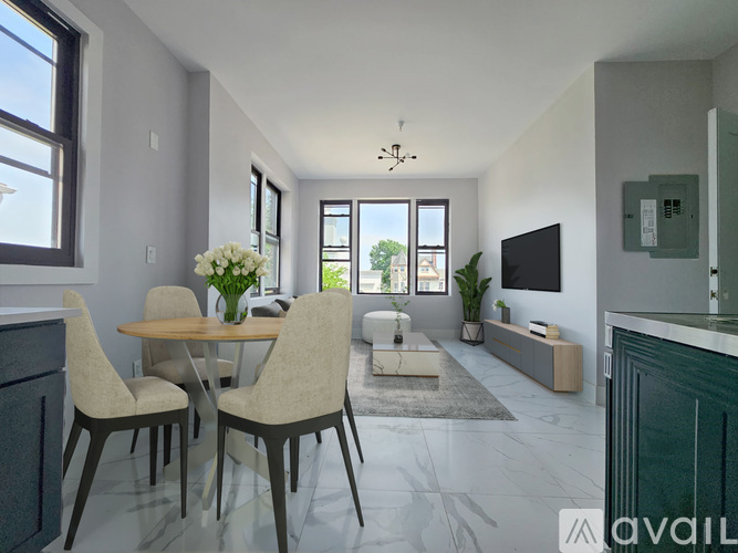 A modern living room with a dining table and chairs.