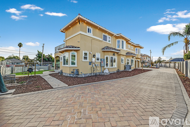 A row of houses with a brick pathway leading to the first house.