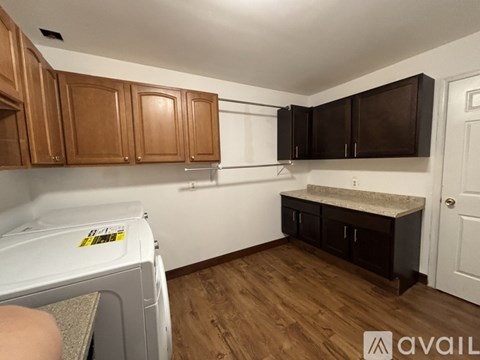 A kitchen with wooden cabinets and a white dishwasher.