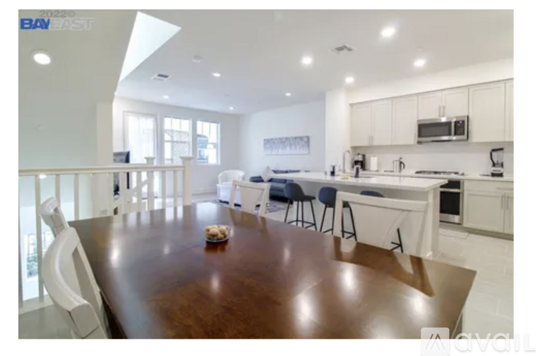 A modern kitchen with a dining table and chairs.