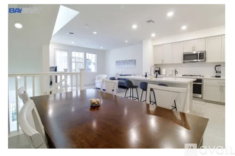 A modern kitchen with a dining table and chairs.