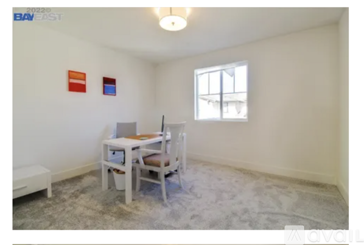 A room with a table and chairs in it.