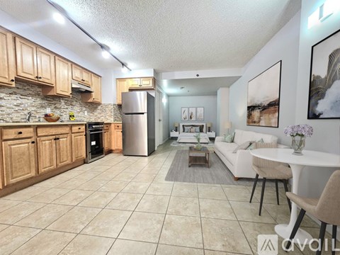 A kitchen with wooden cabinets and a tiled floor.