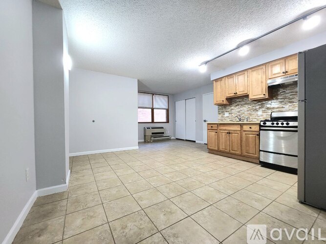 A kitchen with a stove and cabinets is available for rent.