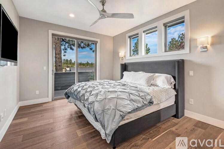 A bedroom with a large bed and a ceiling fan.