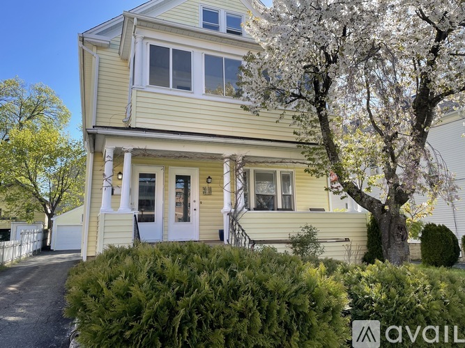 A two-story house with a white door and windows.