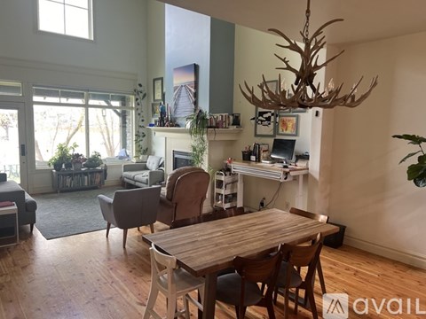 A living room with a wooden table and chairs.