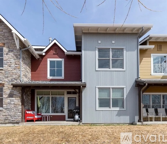 A modern house with a red and grey exterior.