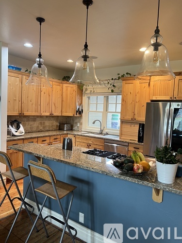 A kitchen with wooden cabinets and a granite countertop.