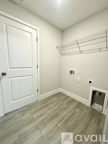 A white door is on the left and a white shelf is on the right.