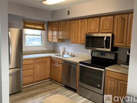 A kitchen with wooden cabinets and stainless steel appliances.