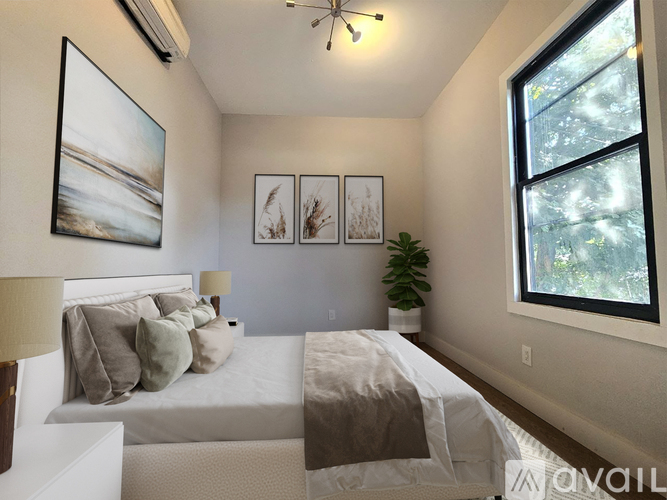 A bedroom with a large bed and a painting on the wall.