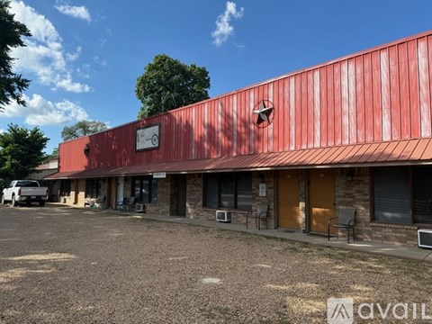 A red building with a white sign on it.