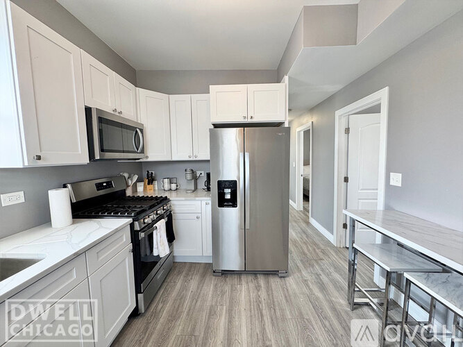 A kitchen with a stove top oven and a refrigerator.