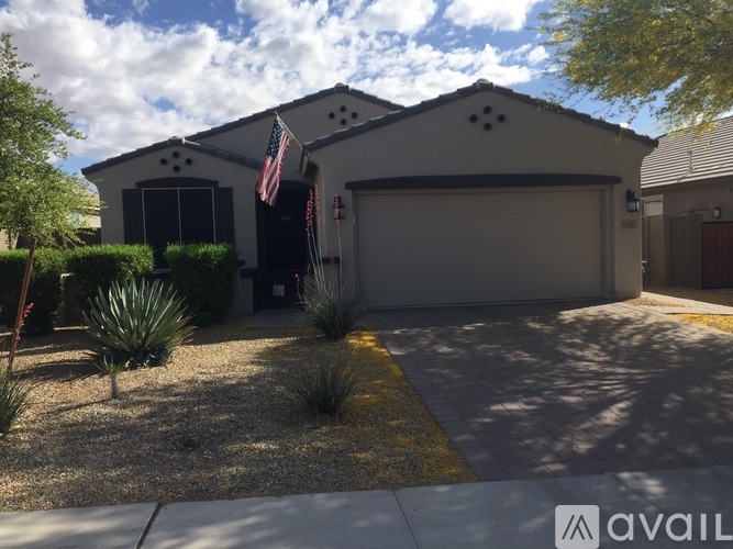 A house with a flag on the front and a garage door.