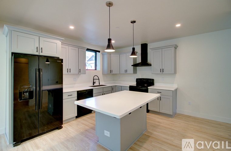 A kitchen with a white island in the middle.