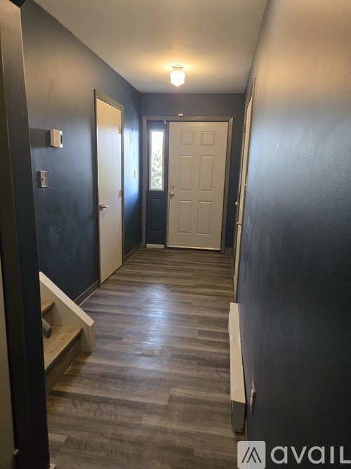 A hallway with a light on and doors on either side.
