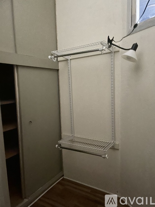 A white shelving unit with a light on it.