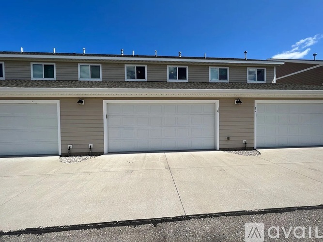 A row of garage doors in front of a building.