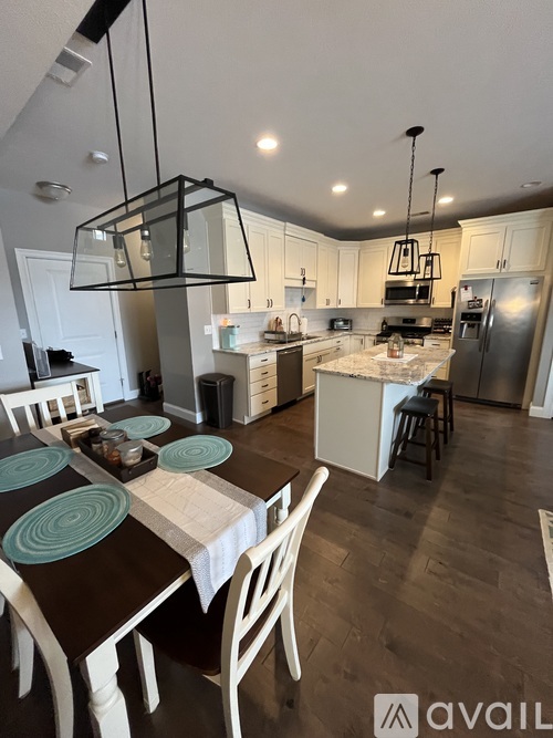 A kitchen with a table set for four.