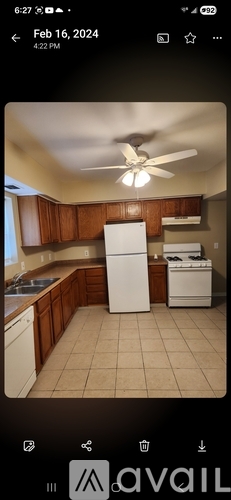 A kitchen with a white refrigerator and a white dishwasher.