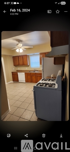 A kitchen with a stove and a ceiling fan.