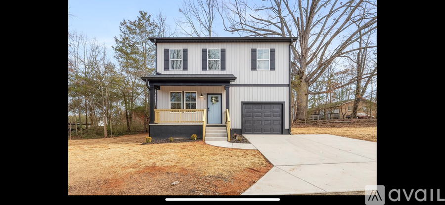 A two-story house with a garage is available for rent.