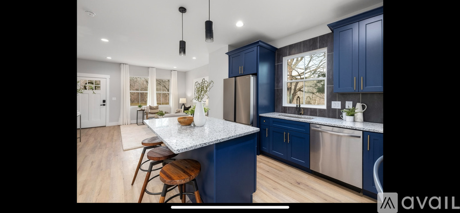 A kitchen with blue cabinets and a white island.