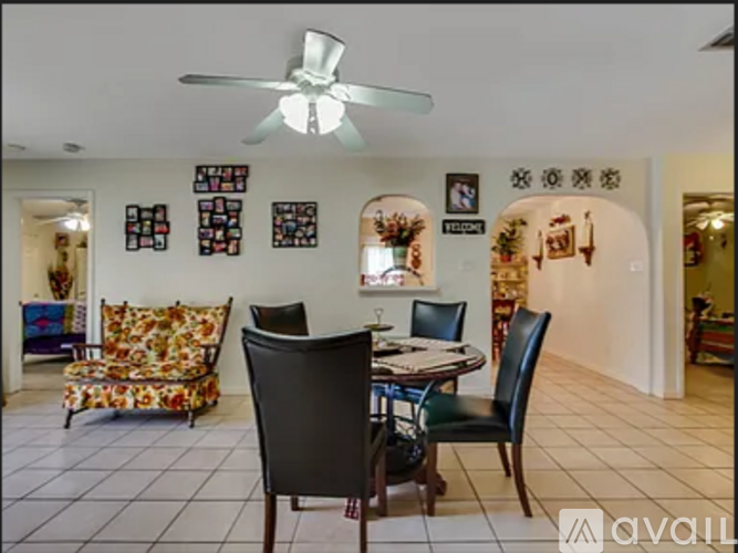 A dining room with a table set for four.